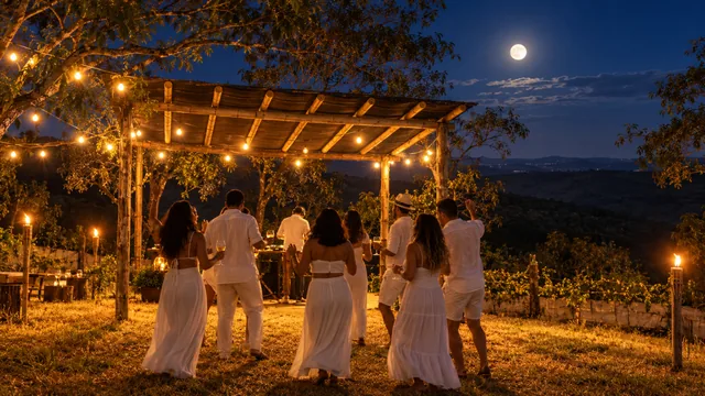 Luau no mirante com pessoas de branco, pergolado iluminado e lua cheia